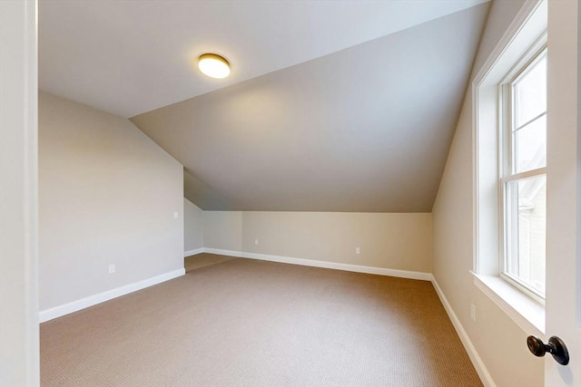 bonus room featuring carpet and vaulted ceiling