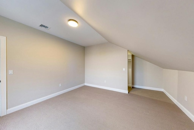 bonus room with carpet flooring and lofted ceiling