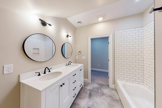 bathroom with shower / bathing tub combination, vanity, and lofted ceiling