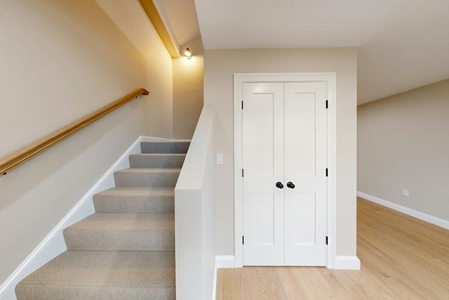 stairs featuring hardwood / wood-style flooring