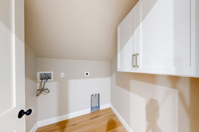 washroom featuring cabinets, washer hookup, light wood-type flooring, and hookup for an electric dryer