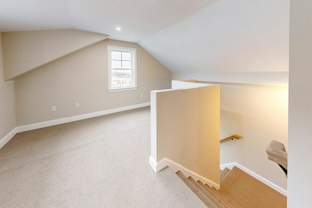 bonus room with light carpet and lofted ceiling