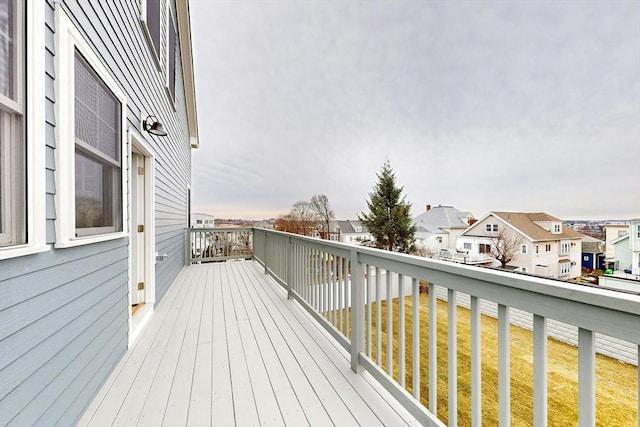 wooden terrace with a lawn