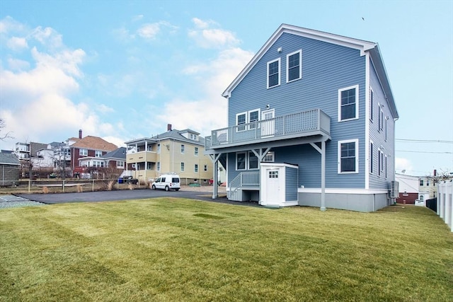 back of property featuring a yard and a balcony