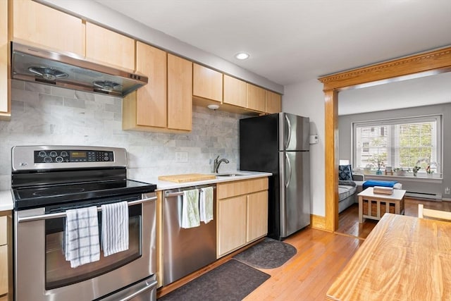 21 Fallon Ct Unit 21, Quincy, MA 02169 - kitchen with stainless steel appliances, under cabinet range hood, light countertops, light brown cabinetry, and recessed lighting