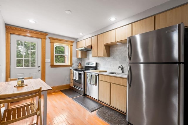 21 Fallon Ct Unit 21, Quincy, MA 02169 - kitchen featuring stainless steel appliances, light wood finished floors, light countertops, backsplash, and light brown cabinetry