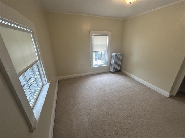 36 Edwards St, Quincy, MA 02169 - empty room featuring radiator heating unit, ornamental molding, baseboards, and carpet