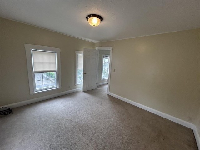 36 Edwards St, Quincy, MA 02169 - empty room with healthy amount of natural light, baseboards, and carpet