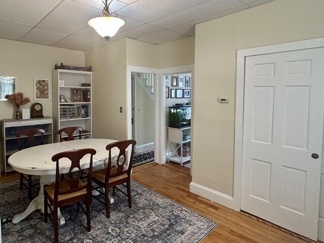36 Edwards St, Quincy, MA 02169 - dining room featuring a paneled ceiling, light wood finished floors, and baseboards