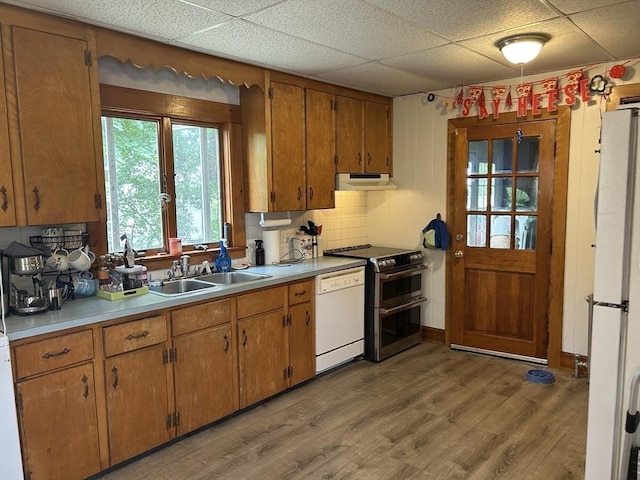 36 Edwards St, Quincy, MA 02169 - kitchen with under cabinet range hood, white appliances, a paneled ceiling, a sink, and light countertops