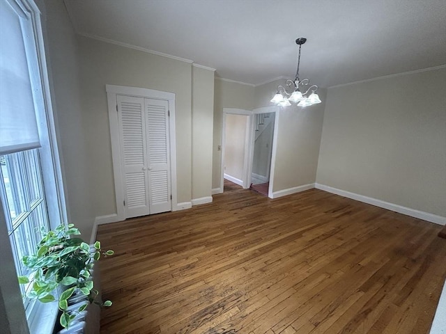 36 Edwards St, Quincy, MA 02169 - unfurnished dining area featuring wood finished floors, a chandelier, ornamental molding, and baseboards
