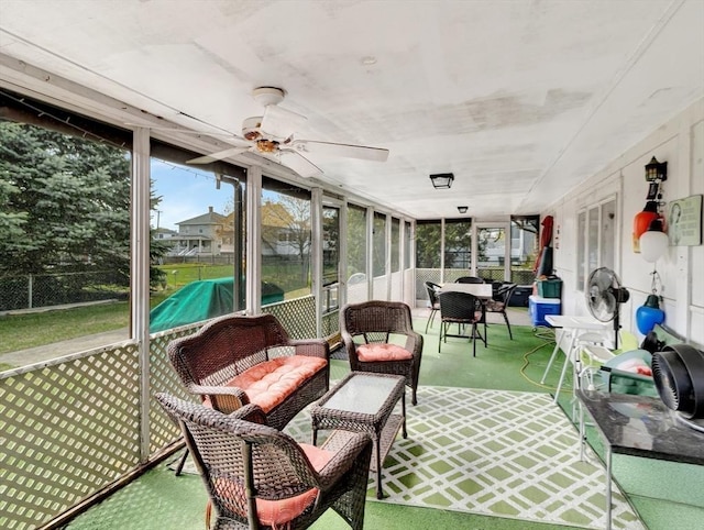 sunroom featuring ceiling fan and plenty of natural light