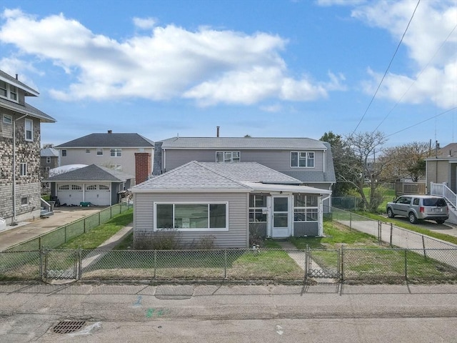 traditional home featuring a gate, a sunroom, and roof with shingles