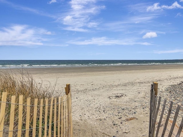 water view with nearby beach and fence