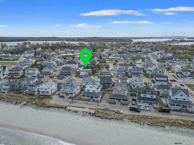 aerial view of residential area with expansive beach
