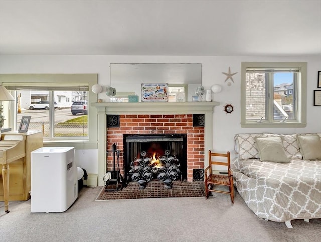 living area featuring carpet flooring and a brick fireplace