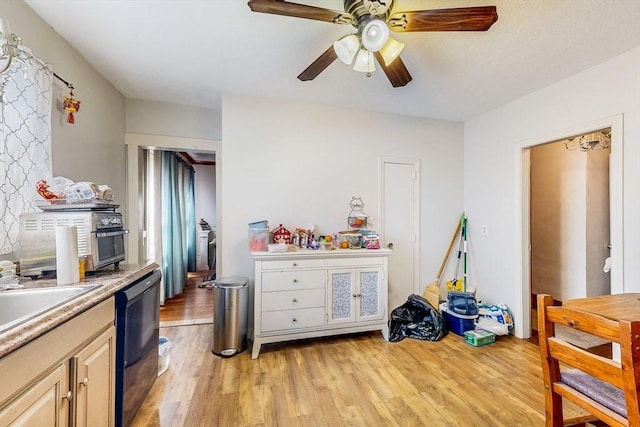 interior space featuring a ceiling fan, a sink, and light wood-type flooring