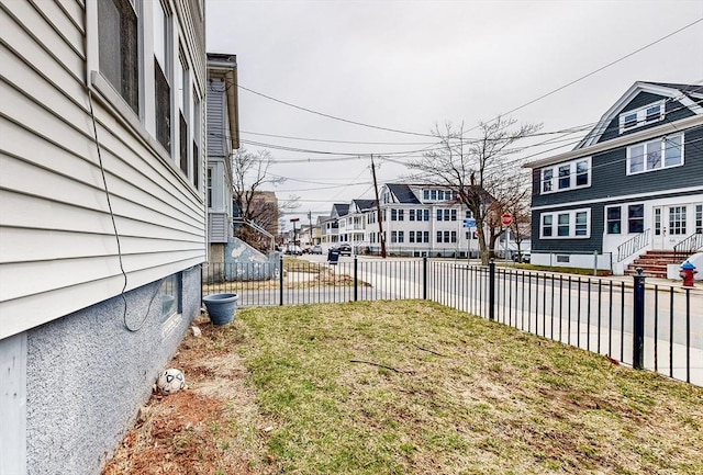 view of yard with fence and a residential view