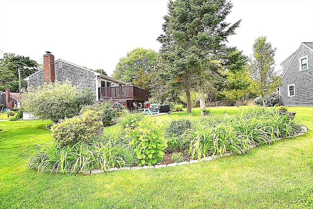 view of grassy yard featuring a deck
