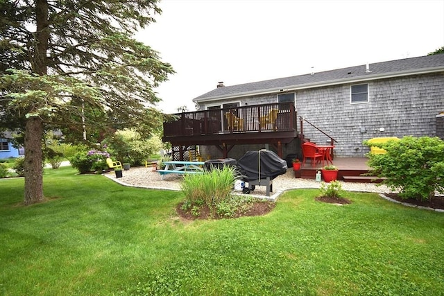 rear view of property featuring a wooden deck, a lawn, a chimney, and a patio