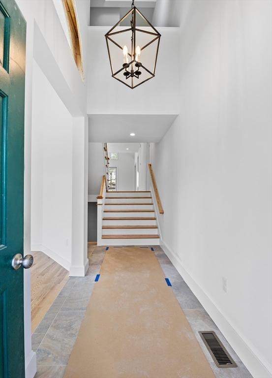 entrance foyer with a chandelier and a high ceiling