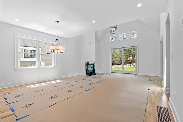 unfurnished living room featuring vaulted ceiling