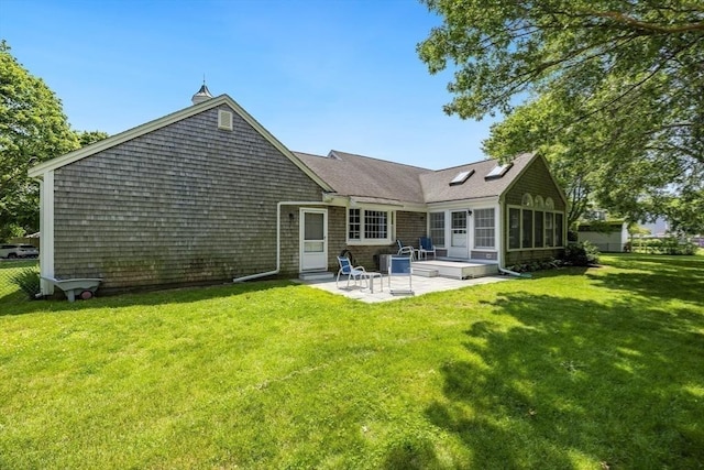 24 Emerald Ln, Falmouth, MA 02536 - back of house featuring a patio, a yard, and a sunroom