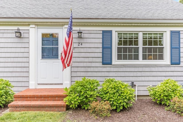 24 Emerald Ln, Falmouth, MA 02536 - view of exterior entry featuring roof with shingles