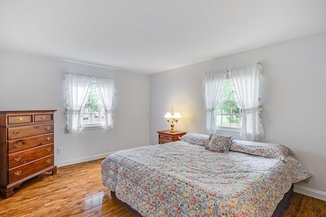 24 Emerald Ln, Falmouth, MA 02536 - bedroom with multiple windows and wood finished floors
