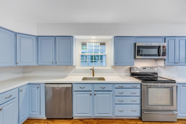 24 Emerald Ln, Falmouth, MA 02536 - kitchen featuring stainless steel appliances, blue cabinetry, and light countertops