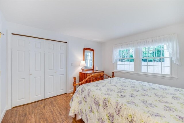 24 Emerald Ln, Falmouth, MA 02536 - bedroom featuring wood finished floors and a closet