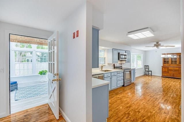 24 Emerald Ln, Falmouth, MA 02536 - kitchen with stainless steel appliances, light countertops, light wood-style flooring, a ceiling fan, and gray cabinetry
