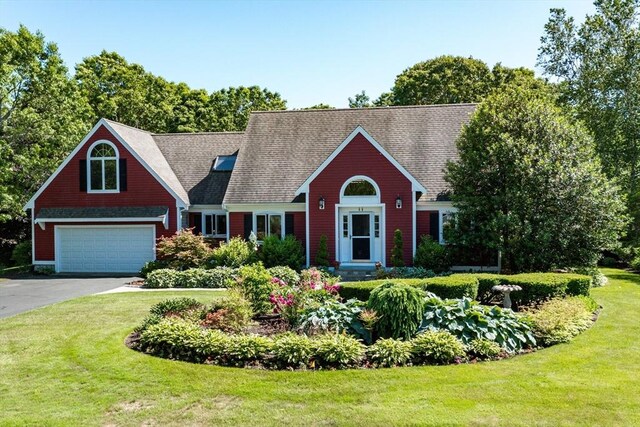 11 Polaris Dr, Mashpee, MA 02649 - view of front of property with driveway, a front yard, a shingled roof, and a garage
