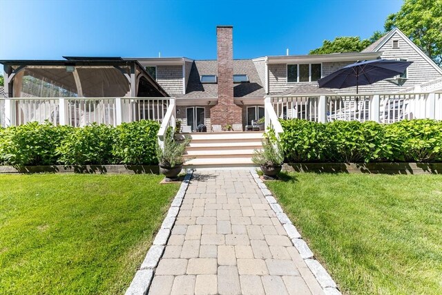 11 Polaris Dr, Mashpee, MA 02649 - rear view of property with roof with shingles, a chimney, and a yard