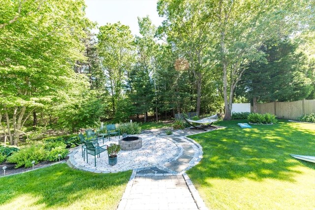 11 Polaris Dr, Mashpee, MA 02649 - view of yard featuring fence and a fire pit