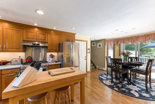 11 Polaris Dr, Mashpee, MA 02649 - kitchen featuring light wood finished floors, brown cabinets, stainless steel appliances, and under cabinet range hood