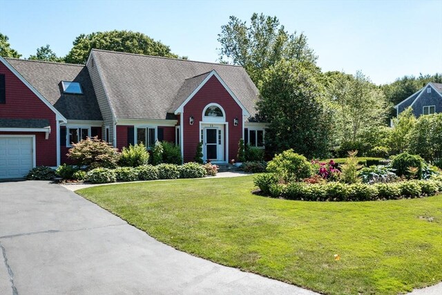 11 Polaris Dr, Mashpee, MA 02649 - view of front of house with a front yard, driveway, and a garage