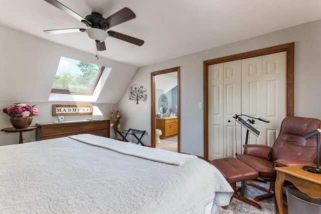 11 Polaris Dr, Mashpee, MA 02649 - bedroom with connected bathroom, a closet, ceiling fan, lofted ceiling with skylight, and light colored carpet