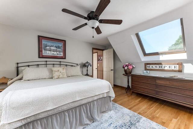 11 Polaris Dr, Mashpee, MA 02649 - bedroom with wood finished floors, a ceiling fan, and lofted ceiling with skylight