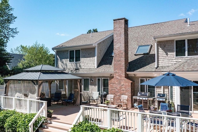 11 Polaris Dr, Mashpee, MA 02649 - back of house featuring a chimney, a gazebo, a shingled roof, and a deck