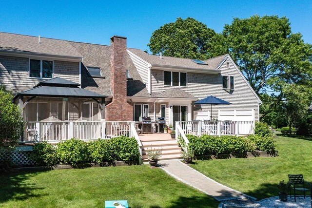 11 Polaris Dr, Mashpee, MA 02649 - rear view of property with a wooden deck, a gazebo, a chimney, roof with shingles, and a yard