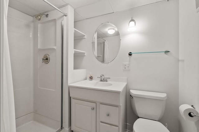 bathroom with a stall shower, toilet, and vanity