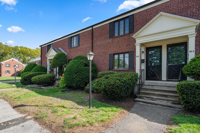 view of front of home featuring brick siding