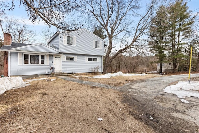 view of front of house featuring a chimney