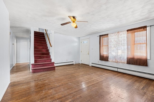 interior space featuring a baseboard radiator, stairway, and hardwood / wood-style floors