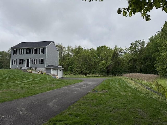 200 Pine St, Rehoboth, MA 02769 - view of side of home featuring an attached garage, asphalt driveway, a yard, and a wooded view