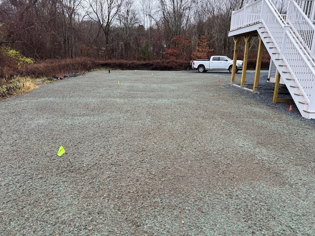 view of parking / parking lot featuring stairway