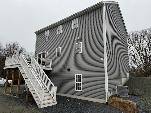 back of property featuring a deck, stairway, and central air condition unit