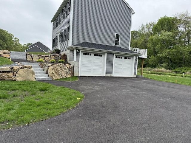 200 Pine St, Rehoboth, MA 02769 - view of side of home featuring a garage, driveway, and stairway