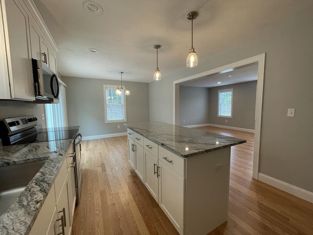 200 Pine St, Rehoboth, MA 02769 - kitchen featuring stainless steel appliances, baseboards, light wood-style floors, a kitchen island, and white cabinets